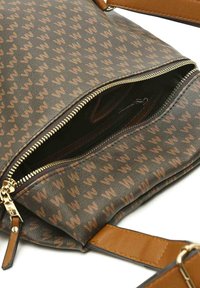 Brown patterned handbag with a zippered top, featuring a gold zipper and brown faux leather straps. Interior has a zip pocket.