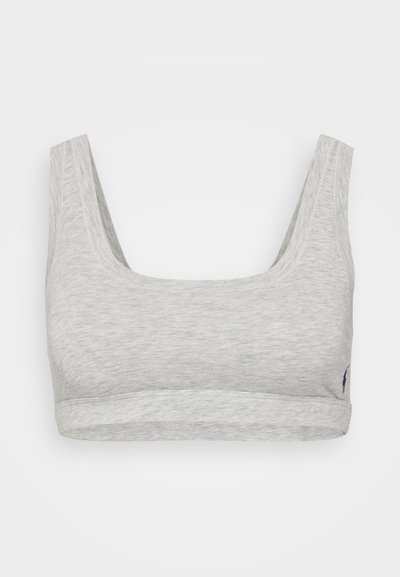 Gray, soft cotton bralette with wide straps and a rounded neckline. Features a fitted band at the bottom and a small logo detail on the side.