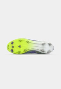Soccer cleats with a textured, multicolored upper featuring purple and green accents, a bright green outsole, and eight studded spikes.