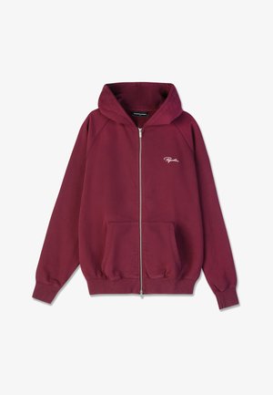 Lietussarkans kapuce ar rāvējslēdzēju un priekšējām kabatām, ribotām piedurknēm un apakšmalu, neliels balts izšūts logo kreisajā krūtī un kapuce.