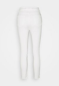 White jeans with a fitted design, made of denim material. Features a mid-rise waistband and two back pockets, with a smooth texture.