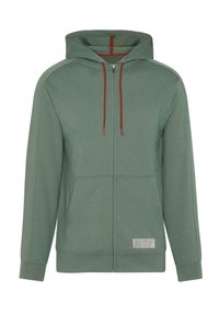 Grüne Zip-Hoodie mit Zugbandkapuze, Fronttaschen und strukturierter Oberfläche. Mit kontrastierenden roten Zugbändern und einem Etikett am Saum.