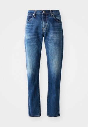 Calças de ganga denim azul-escuro com corte reto, cinco bolsos, detalhes desbotados e fecho à frente com botão e braguilha.