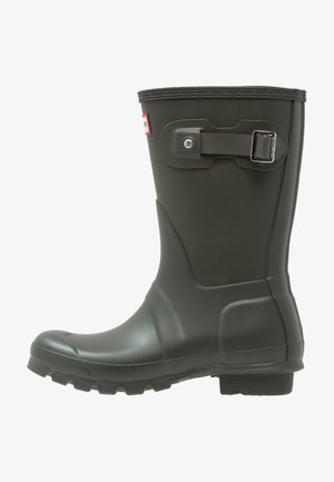 Botte de pluie en caoutchouc noir avec une surface texturée, un embout rond et un détail à boucle sur le côté ; conçue pour les conditions humides avec une semelle robuste.