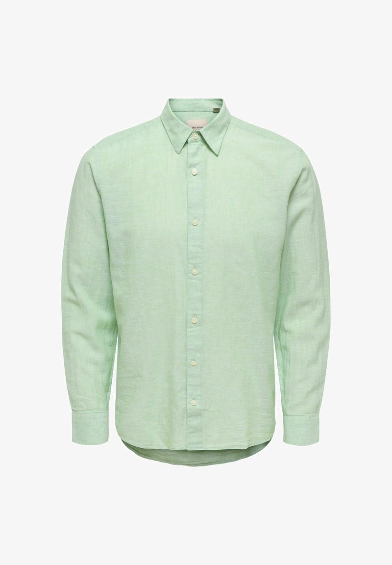 Chemise vert clair à manches longues avec col pointu et poignets boutonnés, en tissu texturé.