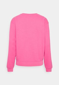 Felpa in pile di colore rosa brillante, con colletto rotondo, maniche lunghe e polsini a costine. Tessuto liscio con orlo leggermente accorciato.