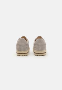 Gray suede shoes with a low profile, rounded toe, beige rubber sole, and subtle stitching details on the back.