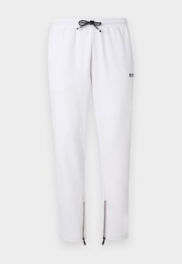 Λευκό slim-fit παντελόνι φόρμας με ασπρόμαυρο κορδόνι, πλαϊνές τσέπες, μικρό λογότυπο στο πλάι και φερμουάρ στους αστραγάλους με τρίχρωμη επένδυση.