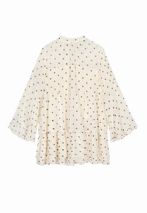 Crème-kleurige blouse met gelaagde tiers, lange klokmouwen en een stippenpatroon in donkerbruin. Lichtgewicht, transparante stof met een ontspannen pasvorm.