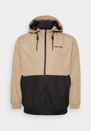 Beige and black color-blocked jacket with a hood, zip closure, elastic cuffs, and a drawstring hem; features "JACK&JONES" logo on front.