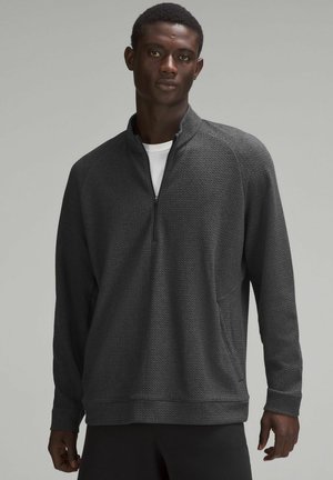 Donkergrijze kwart-rits pullover van textuurstof, met lange mouwen en zijzakken. Biedt een relaxte pasvorm en minimale naden voor comfort.