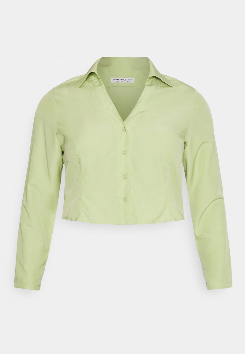 Blusa de mangas longas encurtada em tecido verde claro. Apresenta um colarinho, fecho de botão à frente e uma textura suave.