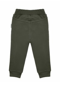 Spodnie dresowe w oliwkowej zieleni o miękkiej fakturze, z elastycznym pasem i dopasowanymi mankietami. Bez widocznych wzorów ani akcentów. Prosty fason z nogawkami o prostym kroju.