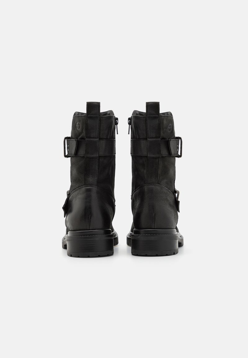 Schwarze Leder-Ankle-Boots mit mattem Finish, ausgestattet mit einem Reißverschluss, verstellbaren Riemen und einer robusten Gummisohle.