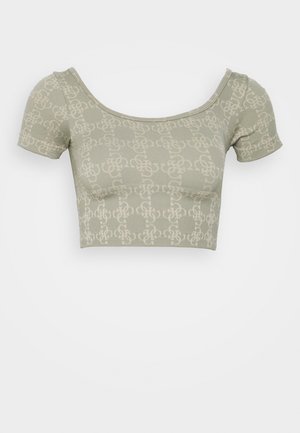 Light green cropped top with short sleeves and all-over subtle interlocking chain pattern on plain background.