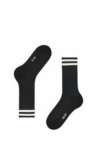 Czarne skarpetki z żebrowanym wzorem, z białymi paskami na górze. Logo widoczne na podeszwie. Elastyczny mankiet dla lepszego dopasowania.