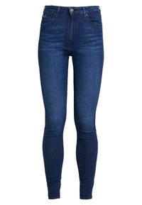 Jeans ajustados de tiro alto en azul oscuro con botón frontal, cremallera y estilo de cinco bolsillos, con un sutil desvanecimiento en los muslos y las rodillas.