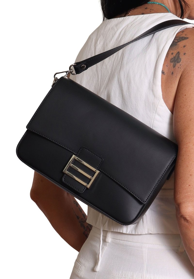 Zwarte leren schoudertas met een rechthoekige vorm, voorzien van een voorklep en een zilveren gespaccent. Gladde textuur en verstelbare schouderband.