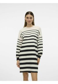 Abito a maglia a righe con strisce orizzontali nere e crema, maniche lunghe, scollo rotondo e vestibilità rilassata. Tessuto morbido e lunghezza a metà coscia.