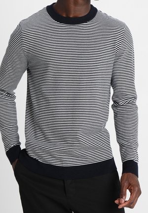 Pull en tricot rayé bleu marine et blanc avec de longues manches, col et poignets côtelés. La texture du matériau semble lisse et le design est ajusté.