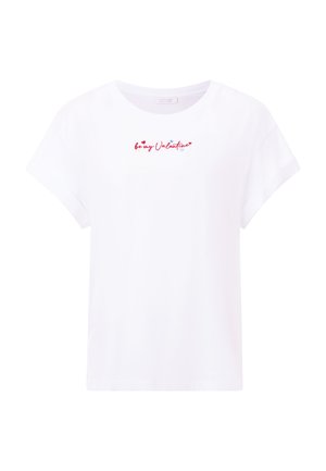T-shirt en coton blanc avec des manches courtes roulées et un col rond. Il comporte un texte rouge et bleu "sois mon Valentin" avec des accents en forme de cœur.