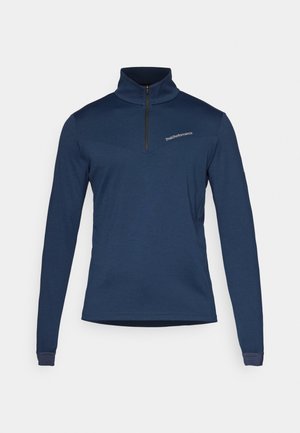 Pullover a maniche lunghe blu navy con zip al collo, realizzato in tessuto morbido. Presenta un design con pannello diagonale e un logo discreto sul petto.