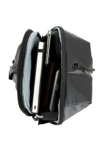 Black backpack with a zippered opening, featuring compartments for a notebook, a pen, a phone, and a wallet. Grey interior lining.