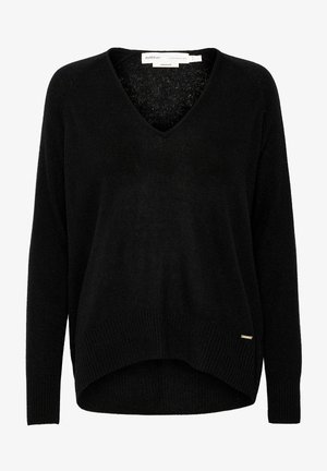 Svart stickad tröja med V-ringning, långa ärmar och en något längre nederkant bak. Har ribbade ärmmuddar och en liten guldkantad etikett.