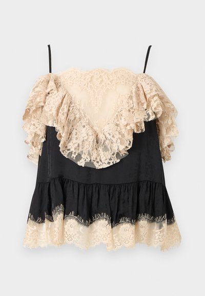 Μαύρο μίνι φόρεμα με μπεζ δαντελωτές βολάν στα μανίκια, το ντεκολτέ και το στρίφωμα, με λεπτές μαύρες τιράντες στους ώμους.