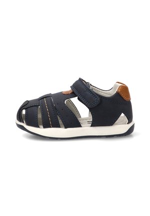 Sandalia infantil azul marino con tira ajustable, diseño de puntera abierta, parche marrón en el talón y suela blanca para comodidad y soporte.