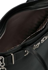 Zwarte leren handtas met textuur, voorzien van zilverkleurige hardware en rits, met een open hoofdvak met donkerbruine voering en een gewatteerd binnenvak.