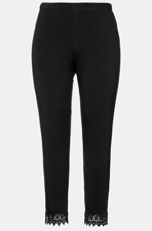Leggings neri con elastico in vita e pizzo sul fondo, realizzati in un materiale morbido e elasticizzato.