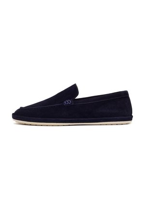 Black suede slip-on loafer with beige sole, rounded toe, and minimal stitching details on a plain white background.