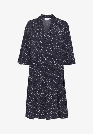 Marineblaues knielanges Kleid mit weißem Herzmuster, dreiviertellangen Ärmeln, gerafften Manschetten, gestuftem Rock und V-Ausschnitt.