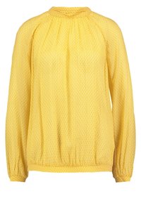 Blouse jaune à motifs avec des manches longues, présentant un col froncé et des poignets élastiques, fabriquée dans un tissu léger et texturé.