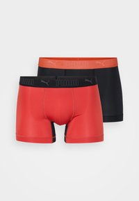 Two pairs of boxer briefs: one red with a black waistband, one black with a red waistband. Both feature the Puma logo on the elastic.