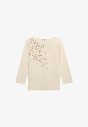 Camisa de manga larga color crema con un corte holgado, que presenta un patrón de puntos dorados dispersos en un lado y un escote redondo. Fabricada en suave material de algodón.