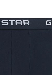 Boxer briefs bleu marine avec une ceinture élastique douce arborant le logo blanc "G-Star". Texture lisse et coupe ajustée.