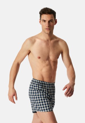 Men's plaid boxers with a blue, white, and beige check pattern. Features a soft fabric, elastic waistband, and a relaxed fit.