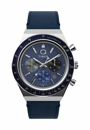 Timex Q hronografa pulkstenis ar zilu ciparu, trim subcipariem, datuma logu 4 stundās, tahometra rāmī un zilu ādas siksnu.