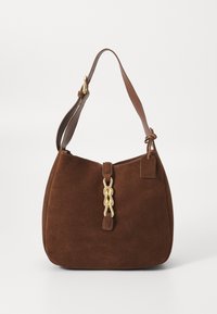 Brown suede shoulder bag with a single leather strap, gold chain detail at the front, and a small tag attached. Rounded shape and soft texture.