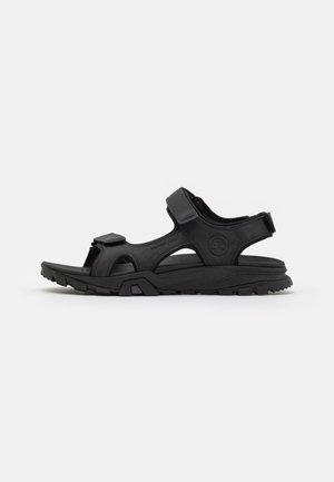 Black adjustable sandal; features open design, textured upper, sturdy sole, and molded footbed for comfort and support.
