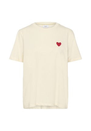 Cream cotton t-shirt with a round neckline and short sleeves, featuring a small red heart design on the left chest area.