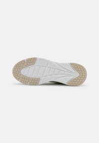 Shoe sole with a white and light brown rubber design. Features a textured surface with geometric patterns and a smooth central section.