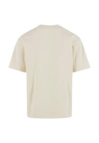 Kortærmet crew-neck t-shirt i cremefarvet, lavet af bomuld. Glat tekstur, ingen mønstre eller accenter, med en standard pasform og en lige bundkant.