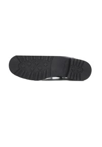 Black rubber shoe sole with textured grip pattern, curved heel, and embossed logo. Sole features stars and parallel lines for traction.