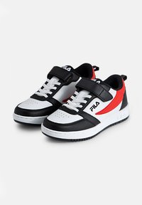 Mustat ja valkoiset urheilujalkineet punaisilla yksityiskohdilla, joissa on sileä nahkapinta, nauhakiinnitys ja tarranauha, sekä kumipohja.