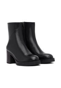 Zwarte leren enkelboots met een gladde afwerking, zijrits, chunky hak en afgeronde neus. Minimalistische en elegante esthetiek.