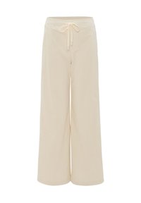 Beige wijde broek gemaakt van zachte stof, met een elastische tailleband en een trekkoord, biedt een comfortabele en ontspannen pasvorm.