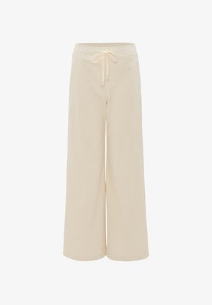 Beige weite Hose aus weichem Stoff, mit einem elastischen Bund und Kordelzug, die einen komfortablen und lockeren Sitz bietet.